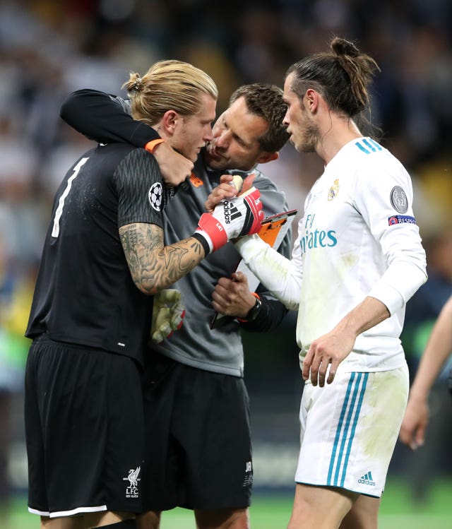 Karius is consoled by Liverpool goalkeeping coach John Achterberg and Bale