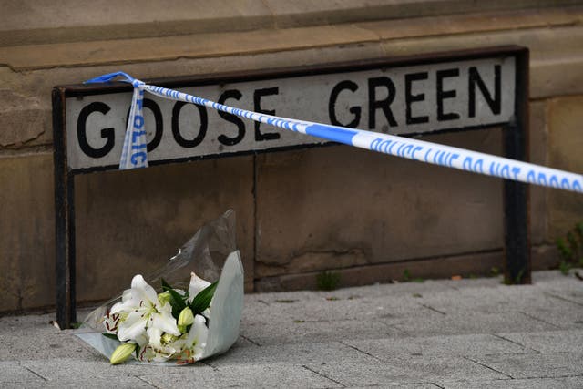 A lone floral tribute at the scene in Railway Street in the Goose Green area of Altrincham