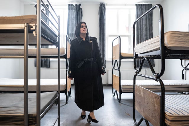 Shabana Mahmood standing in a room with empty bunkbeds