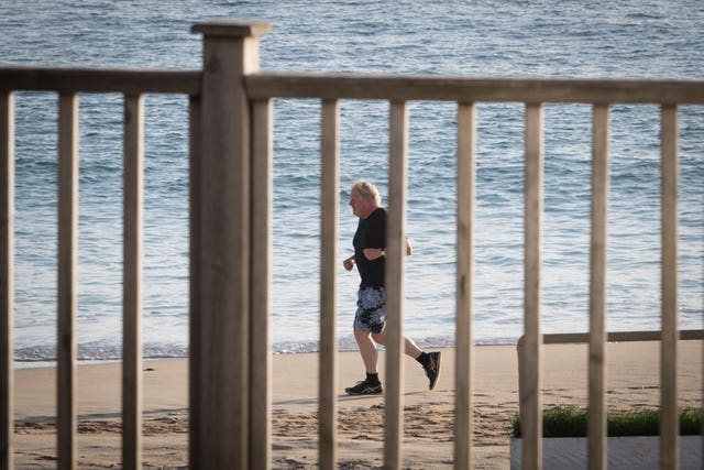 Prime Minister Johnson runs along the beach in Carbis Bay, during the G7 summit in Cornwall