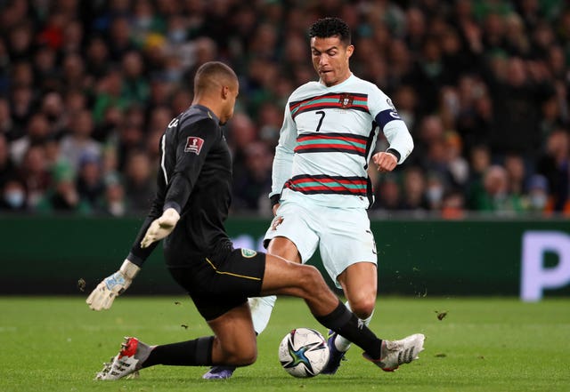 Republic of Ireland goalkeeper Gavin Bazunu tackles Portugal’s Cristiano Ronaldo