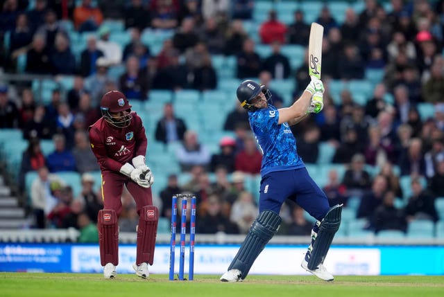 Jos Buttler holds his batting pose after hitting the ball towards the boundary
