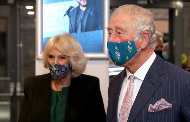 The Prince of Wales and Duchess of Cornwall, wearing masks, during a visit to the Soho Theatre in London. Chris Jackson/PA Wire