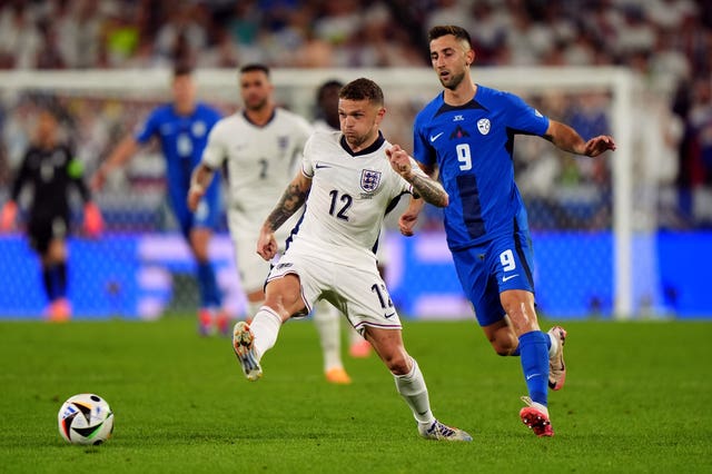 England’s Kieran Trippier plays a pass with the outside of his right foot with Slovenia's Andraz Sporar, right, in pursuit