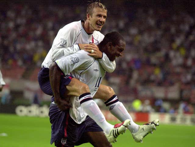 Emile Heskey is embraced by David Beckham after scoring England's third goal against Denmark in 2002 (Rui Vieira/PA).
