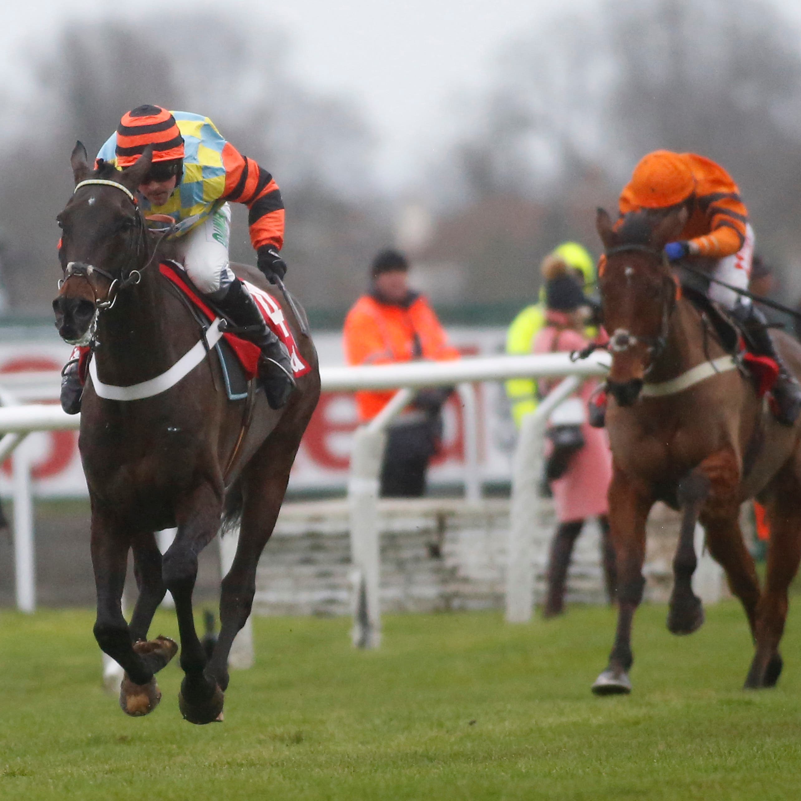 Might Bite (left) strides to victory in last year's King George VI Chase