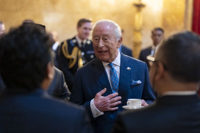 The King greeting guests during a reception at Lancaster House 