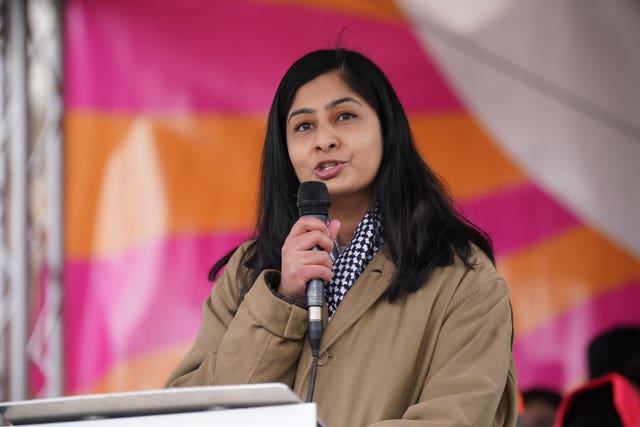 Zarah Sultana speaking into a mic on stage