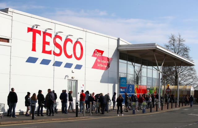 People queue outside a Tesco Extra store in Madeley, Shropshire 