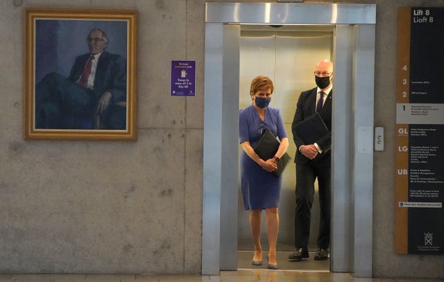 Nicola Sturgeon and John Swinney in a lift, both wearing facemasks