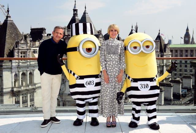 Steve Carell and Kristen Wiig pose with two Minion characters