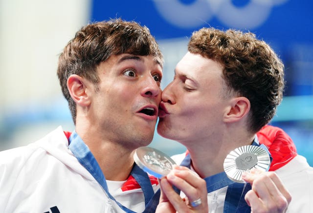 Noah Williams, right, kissing Tom Daley on the cheek