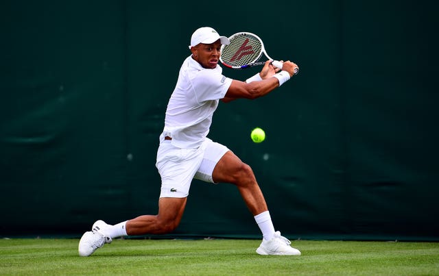 Jay Clarke plays a backhand during his win over Noah Rubin