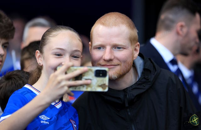 Ipswich Town fan Ed Sheeran poses for photos with fans 