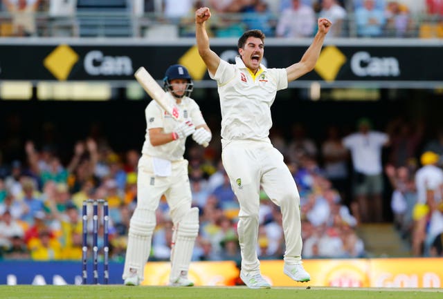 Pat Cummins celebrates the wicket of Joe Root, background, during the 2017-18 Ashes