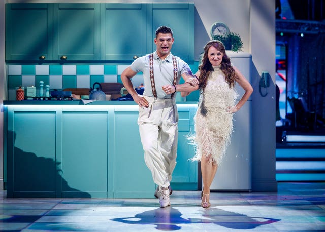 Melanie Walters and Aljaz Skorjanec smiling while performing in the Strictly ballroom