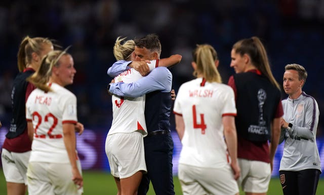 Phil Neville, centre, celebrates with his team