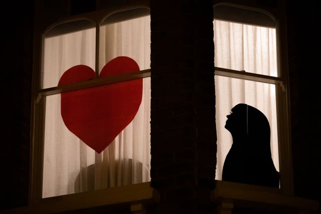 A woman staring at a heart