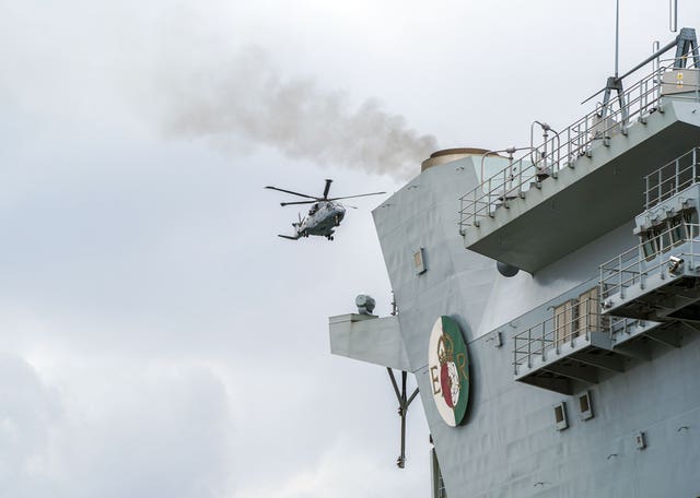 A Royal Navy Merlin helicopter lands on the HMS Queen Elizabeth 