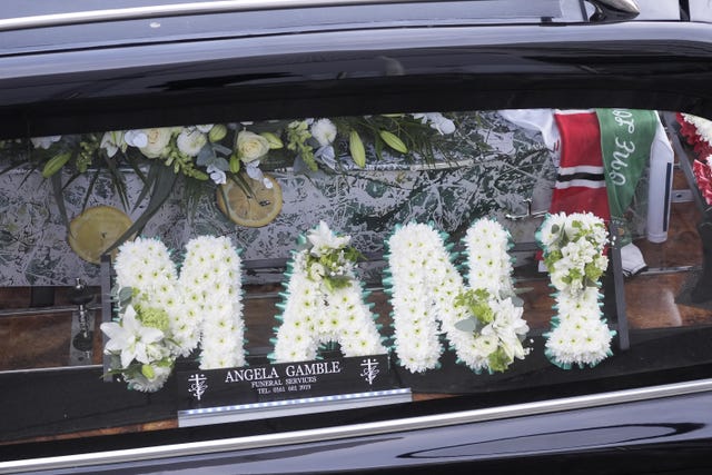 Flowers in the hearse spell 'Mani'