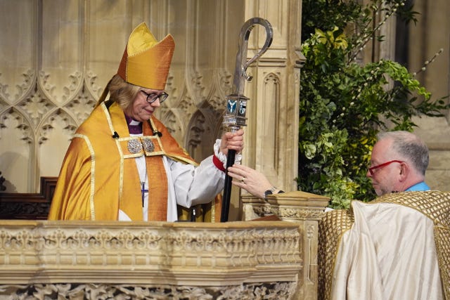 Dean of Canterbury, the Very Rev Dr David Monteith (right) hands the Archbishop of Canterbury the Pastoral Episcopal Staff 