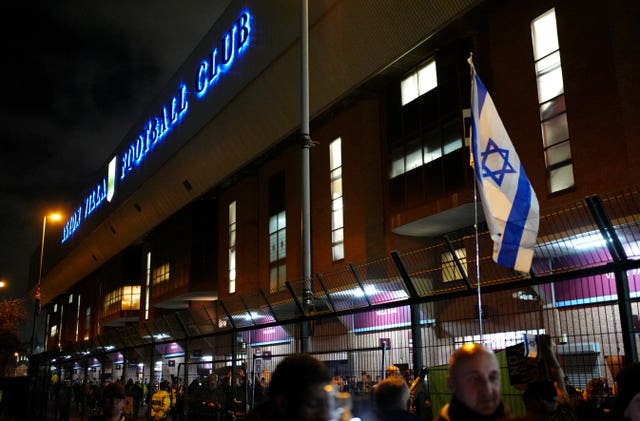 People outside Aston Villa's stadium after dark