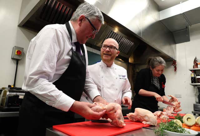 Cabinet Secretary for the Rural Economy Fergus Ewing tries his hand at preparing poultry (Andrew Milligan/PA)