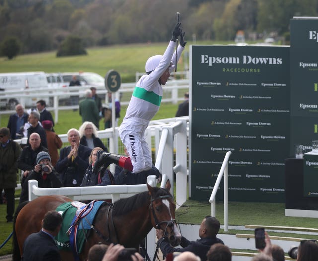 Frankie Dettori celebrates by leaping from Epictetus after winning the Weatherbys Digital Solutions Blue Riband Trial at Epsom Downs