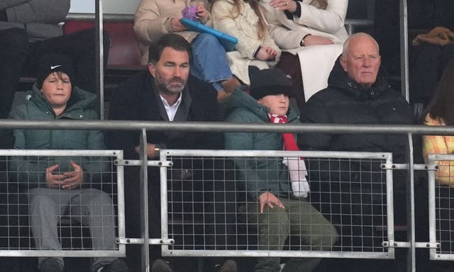 Eddie Hearn and father Barry Hearn sit in the stand