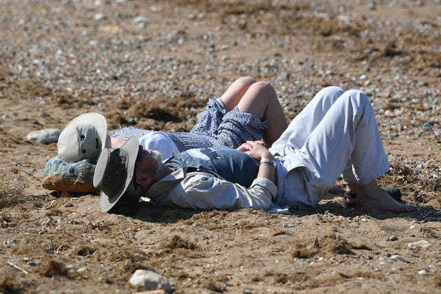 Sunbathers relax on Hunstanton beach in Norfolk (Joe Giddens/PA)