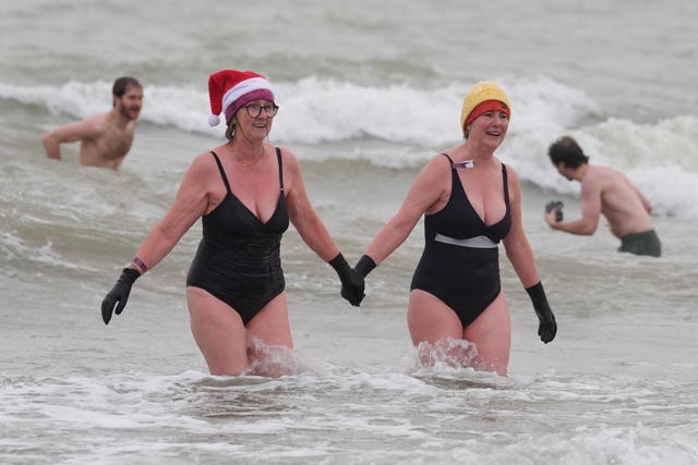 Swimmers take part in the Folkestone Lions’ Boxing Day Dip at Sunny Sands Beach in Folkestone