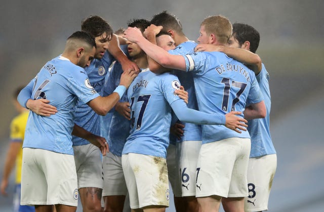 Manchester City players celebrate Phil Foden's goal.