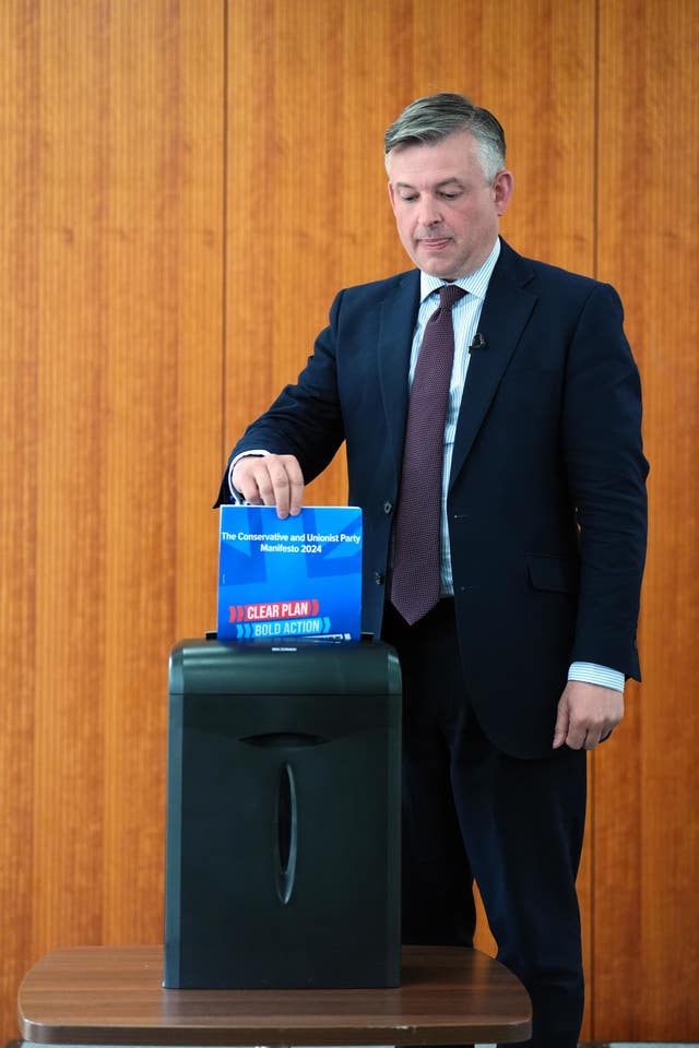 Shadow paymaster general Jonathan Ashworth shreds a copy of the Conservative manifesto (James Manning/PA)