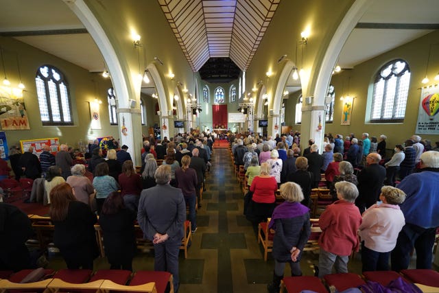 People attend a vigil at St Michael's & All Angels church  (Kirsty O'Connor/PA)