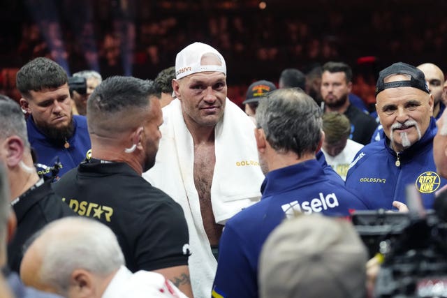 Tyson Fury stands in the ring with a towel around his shoulders after losing to Oleksandr Usyk