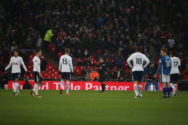 Match referee Paul Tierney consults the VAR