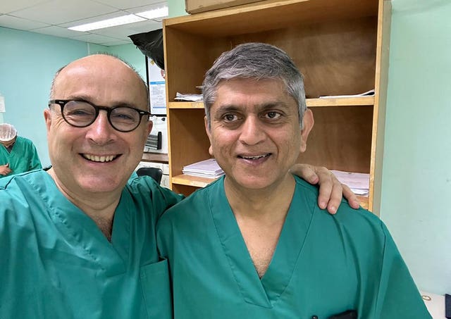 Dr Nick Maynard, left, and Professor Bijen Patel outside a hospital in Gaza