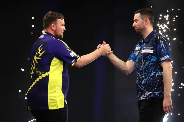 Luke Litler, left, and Luke Humphries shake hands on stage