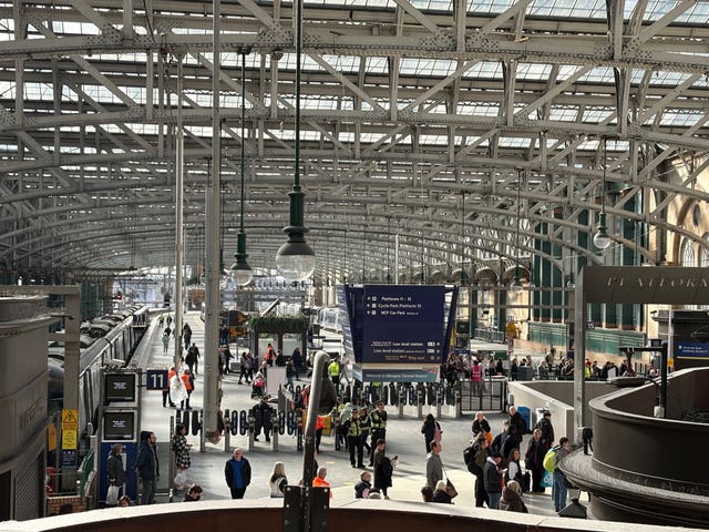 View of the Glasgow Central concourse, with passengers and staff walking around
