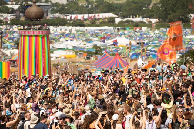 Festival goers enjoy the sun as they dance and listen to music (Aaron Chown/PA)