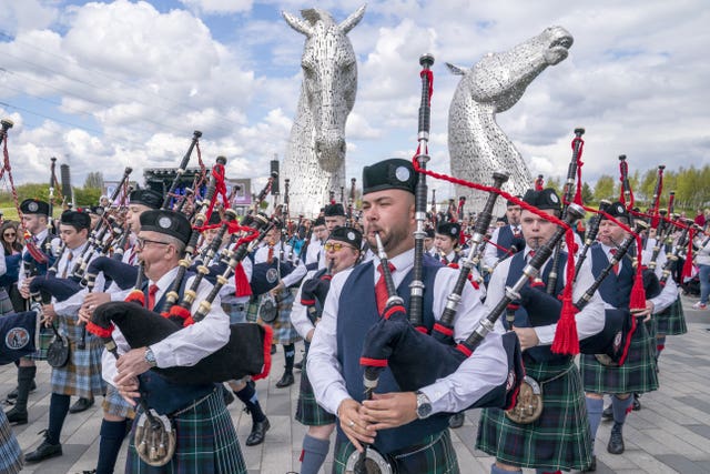 Pipe bands play during a special event day to celebrate the 10th anniversary of the Kelpies sculpture in Falkirk in April