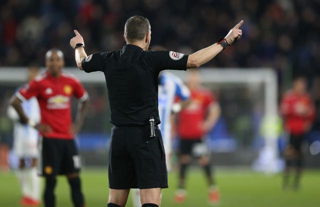Referee Kevin Friend signals that Juan Mata's striker is being reviewed by VAR (Nigel French/Empics)