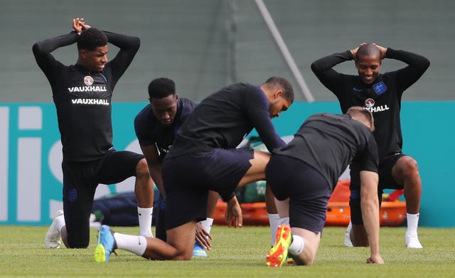 England players go through their stretches on the training pitch