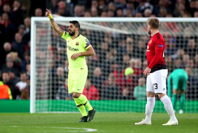 Luis Suarez celebrates after he forced Luke Shaw into scoring an own goal