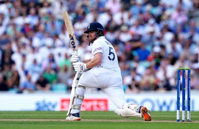 Jonny Bairstow kneels while batting for England.