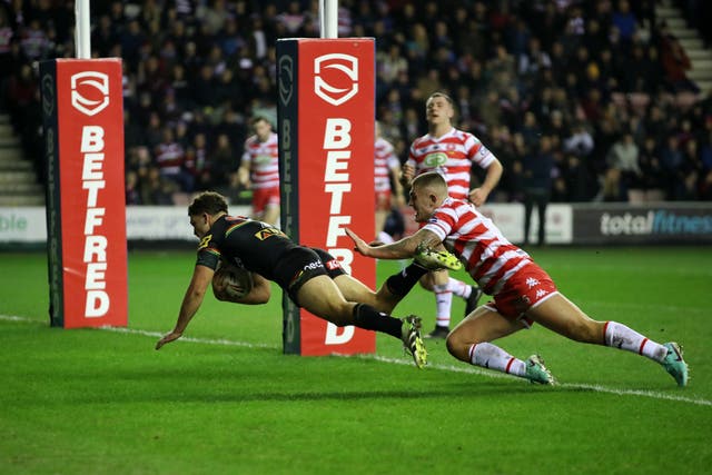 Penrith Panthers’ Nathan Cleary (left) scores his sides first try during the Betfred World Club Challenge match at the DW Stadium