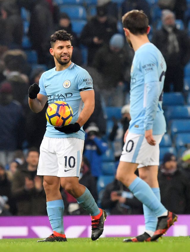 Aguero (left) claimed the match ball after his treble