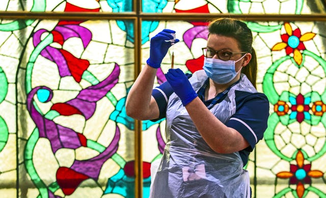 Practice nurse Hannah Currie, 25, prepares a dose of the AstraZeneca vaccine at Bradford Central Mosque (Peter Byrne/PA)