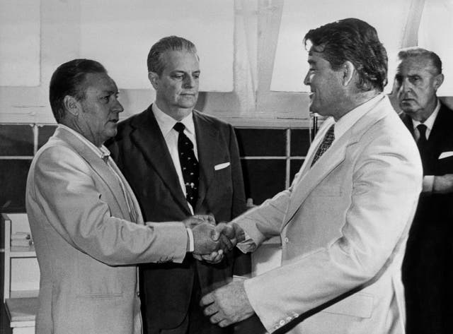 Real Madrid coach Miljan Miljanic (r) shakes hands with successor Luis Molowny (l) after resigning from the club.
