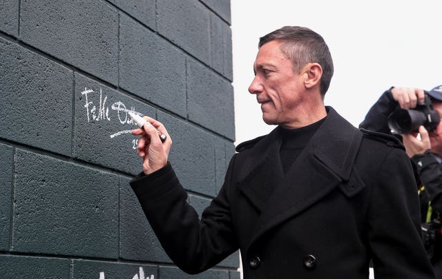 Frankie Dettori signs a new mural of him unveiled at Epsom Downs Racecourse 